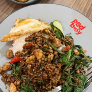 Pork minced pad kra pow, with sunny side up and Thai basil